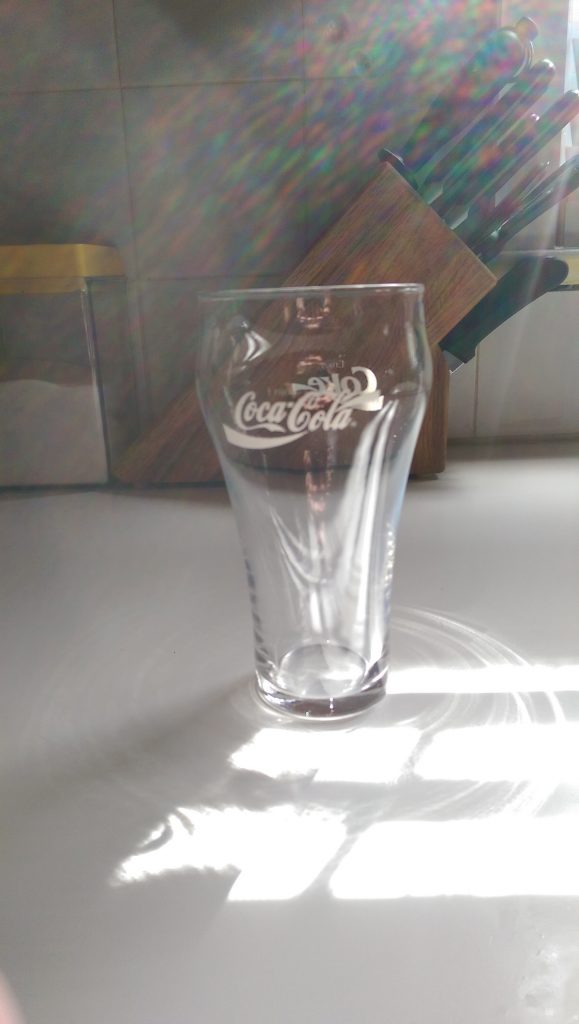 An empty old style Coca~Cola glass
